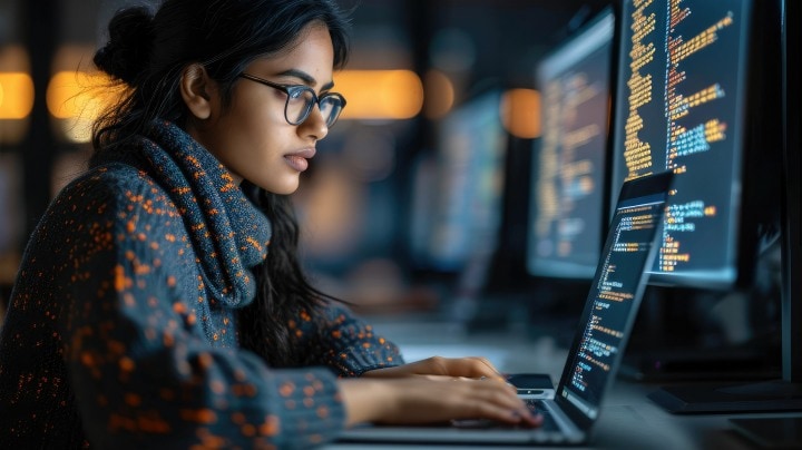  Employee typing and viewing data security on computer screen